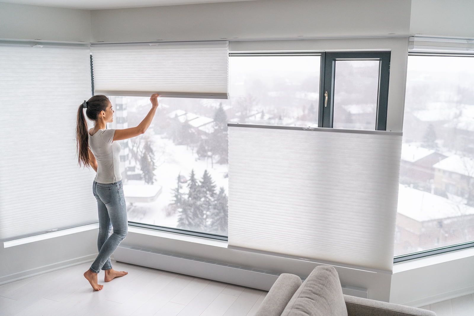 Woman opening honeycomb blinds