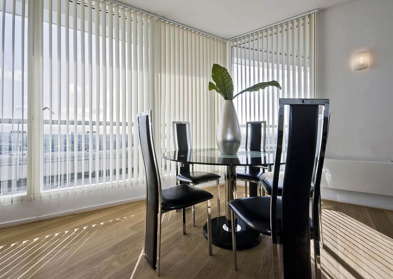 Stylish vertical blinds installed in a dining room